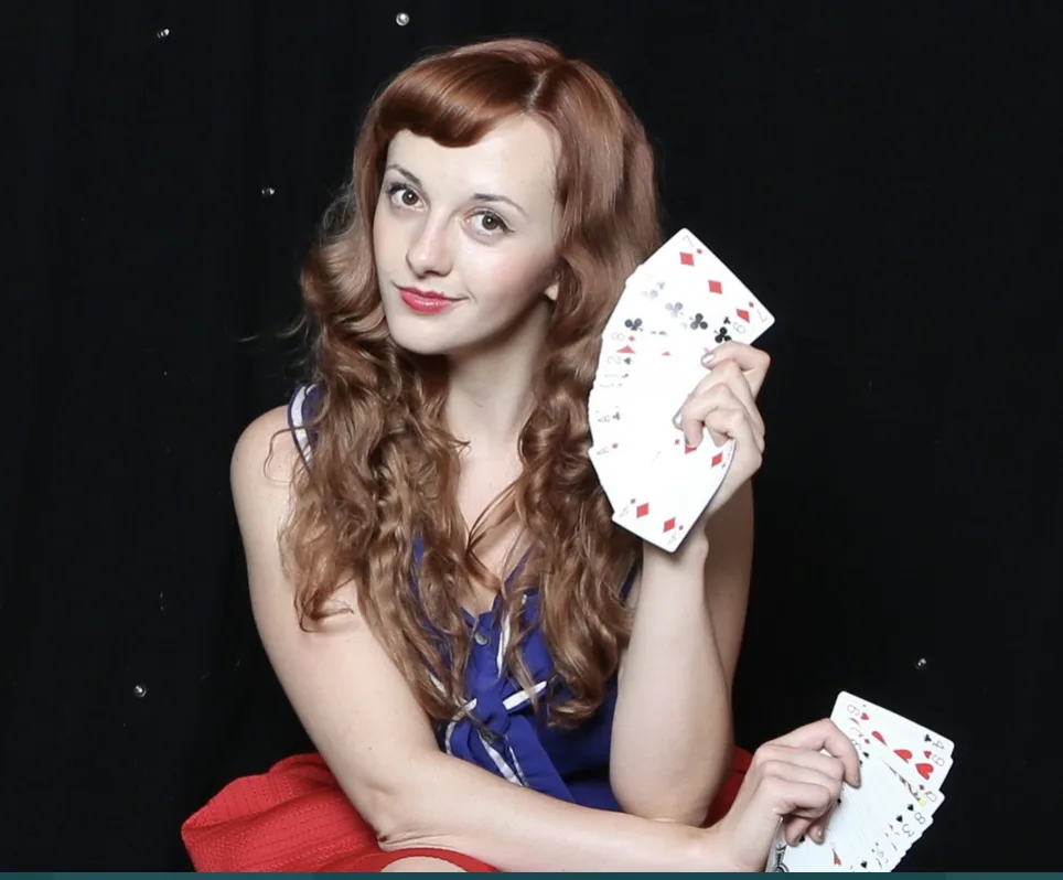 Magical Katrina holding playing cards